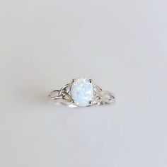 a white opal ring on a plain surface