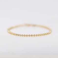 "14K Solid Gold Ball Chain Bracelet, 2mm Gold Beads Bracelet, Simple Minimalist Bracelet, Layering Bracelets, Gifts for Her ≫ Product Details ◈ Handmade / Handcrafted Fine Jewelry ◈ Thickness: 2.0 mm ◈ Metal: Solid 14K Gold ◈ Chain Length: 6\" ~ 7.5\" ≫ Please read our FAQ below for more detail." Gold Sterling Silver Bracelet With Round Beads, Dainty Beaded Bracelets With Ball Chain, Delicate Hypoallergenic Bracelets With Round Beads, Minimalist Hypoallergenic Round Beaded Bracelets, Minimalist Hypoallergenic Beaded Round Bracelets, Minimalist Hypoallergenic Beaded Bracelet, Minimalist Ball Chain Bracelets As Gift, Minimalist Gold Bracelet With Ball Chain, Simple Gold Bracelet With Small Beads