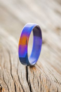 a blue ring sitting on top of a wooden table