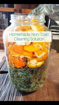 homemade non - tonic cleaning solution in a glass jar filled with fresh herbs and lemons