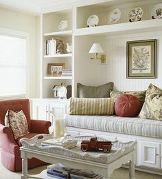 a living room with red and white furniture