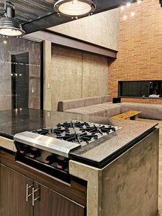 a kitchen with a stove top oven next to a couch