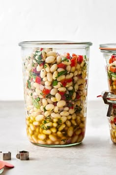 two glass containers filled with beans and vegetables