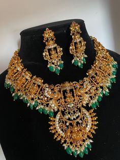 Ashta Lakshmi temple jewelry Necklace with green beads hangings and earrings *Gold Finish *Premium Quality Necklace Type - Short Necklace & has adjustable dori Earrings are pushback. Festive Green Jewelry Sets With Peacock Design, Heavy Green Temple Necklace, Festive Green Kundan Necklace With Latkans, Green Kundan Necklace With Latkans In Temple Style, Green Jewelry With Peacock Design For Festivals, Green Temple Necklace With Latkans, Green Jewelry With Latkans For Festive Occasions, Green Temple Necklace With Latkans For Diwali, Festival Green Jewelry With Peacock Design