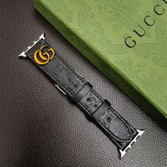 Premium GG Leather Construction: The Ophidia GG Apple Watch band is crafted from high-quality leather, featuring Gucci's signature GG monogram. This luxurious material ensures both durability and a sophisticated aesthetic. Iconic Metal Monogram Detail: The band is adorned with Gucci's iconic metal GG monogram Luxury Adjustable Black Band Watch Accessories, Luxury Durable Black Watch Bands, Designer Gold Leather Watch Accessories, Luxury Black Adjustable Apple Watch Band, Designer Watch Accessories With Leather Strap And Rectangular Shape, Designer Rectangular Watch Accessories With Leather Strap, Luxury Leather Watch Bands, Trendy Black Leather Strap Apple Watch Band, Luxury Black Rectangular Watch Accessories