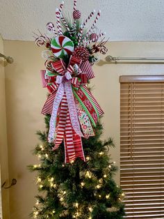 a christmas tree decorated with candy canes and bows