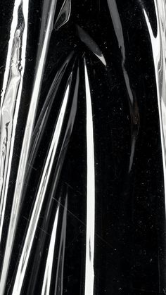 black and white photograph of shiny material with lines in the middle, as if it were plastic