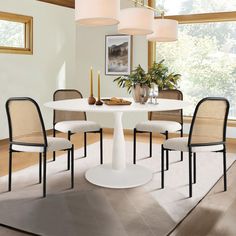 a white table with four chairs around it