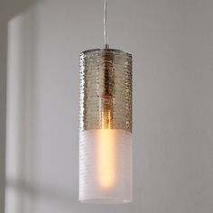 a light fixture hanging from a ceiling in a room with white walls and flooring