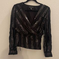 Inc Glitz Sequin Wrap Top Black Size Small Black Glitter Print Top For Night Out, Black Embellished Blouse For Night Out, Black Fitted Top With Glitter Print, Black Glitter Print Party Top, Fitted Black Tops With Glitter Print, Black Shimmer Tops For Night Out, Black Glitter Long Sleeve Top, Black Glitter Tops For Party Season, Black Shimmer Tops For Party