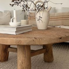 a coffee table with books and a vase on it