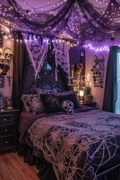 a bedroom decorated in purple and black with string lights