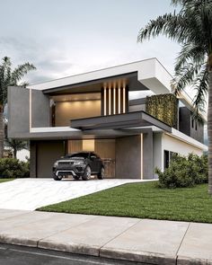 a car is parked in front of a modern house with palm trees and grass on the lawn