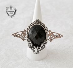 ♥♥Noir Romantique♥♥ Welcome to my store! An impressive ring to make a statement while wearing it . It features a beautiful silver bat attached to a black oval 18x25mm gem placed again over silver bat .This ring is adjustable to fit all fingers Material: Alloy It will be sent to you in a beautiful gift box gift wrapped through registered mail(this means that tracking number will be provided to you as soon as I send your order). If you have any questions feel free to ask:) Thanks for visiting! Vintage Black Rings For Halloween, Unique Black Skull Ring For Halloween, Adjustable Gothic Skull Ring, Gothic Skull Ring For Halloween, Handmade Gothic Skull Ring For Halloween, Gothic Rings, Cameo Ring, Box Gift, Beautiful Gift Boxes