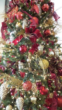 a christmas tree decorated with red and gold ornaments