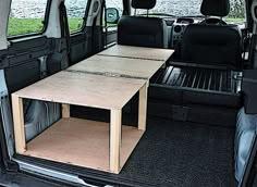 the back end of a van with a table in it