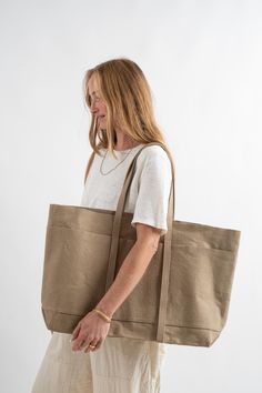 Oversized & functional washed canvas tote. Spacious enough for daily use or travel with dual handles, external straps for yoga mat or jacket storage and open top construction. Three exterior pockets, three internal pockets and a gusseted base. Unlined. 100% Cotton Canvas Made in Japan Jacket Storage, Canvas Travel Bag, Fabric Bags, Shopping Spree, Large Canvas, Open Top, Canvas Tote Bag, Yoga Mat, Sale Design