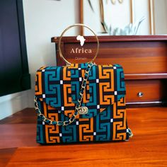 Well designed African bag made using high quality Ankara Prints. It has unique Brass handle, It's spacious and can be used during office and casual. Custom Teacher Appreciation Gifts, Personalized Leather Tote Bag, Jane Birkin Basket, Wooden Handle Bag, Ankara Bags, Organic Bag, Fabric Tote Bag, African Bag, Timeless Bags