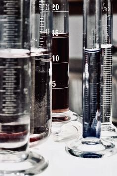 several test tubes filled with liquid on top of a table