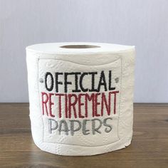 a roll of toilet paper with the words official retirement papers written in pink and blue on it