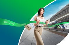 a woman is holding a green ribbon in front of a train and the words executive printed on it