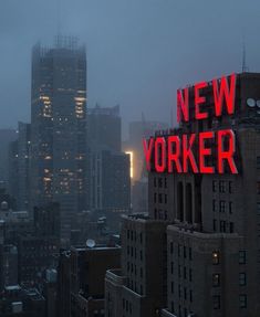 the word new york is lit up in red on top of tall buildings at night