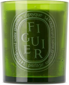 a green glass candle with the words figuer on it