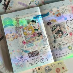 an open planner book with stickers on it