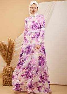 Step into refined elegance with our Lavender Blossom Elegance Crepe Maxi Dress. This captivating dress features a beautiful floral print in soft lavender and violet hues, perfect for adding a touch of grace to any occasion. Crafted from durable crepe polyester, the dress offers both comfort and style with a flowing skirt that moves effortlessly. The high neck and long sleeves provide a modest and sophisticated look, while the unlined design ensures a lightweight feel. Whether for a special event