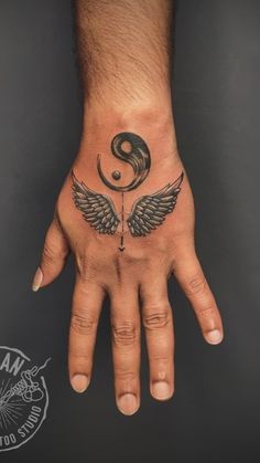 a person's hand with a tattoo on it