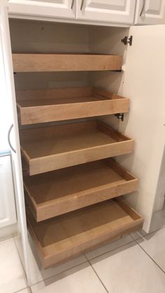 the shelves in this kitchen are made out of wood and have no doors on them