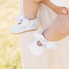 Step into pure elegance with our updated bright white mocc collection! Knotted Bow Mocc Bright White Leather Weathered Brown Leather Sole Choose between soft sole for your infant OR rubber hard sole for your little on the go Soft soles come in sizes Newborn - 7 Hard soles come in sizes 3 - 7 Spring Booties With Soft Sole For Playtime, Cute Spring Booties With Soft Sole, Spring Booties With Soft Sole And Round Toe, Spring Slip-on Booties For Playtime, White Non-slip Booties With Round Toe, Spring Playtime Booties With Rubber Sole, White Booties For First Birthday In Spring, White Booties For First Birthday Spring, White Soft Sole Booties For First Birthday