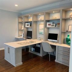 a home office with built in desks and shelves