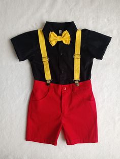 a black shirt and red shorts with a yellow bow tie