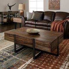 a living room with a couch, coffee table and rug