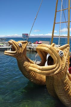 a boat made out of wicker with eyes on it's side in the water