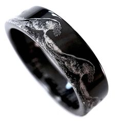 a black ring with an image of a woman on it's side and the words rings paradise written in silver