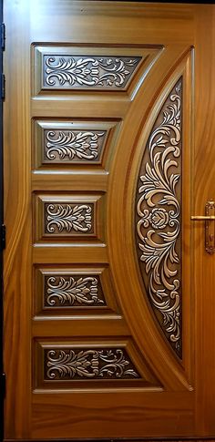 an open wooden door with decorative designs on it