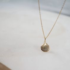 A treasure of the sea, this beautifully crafted 14kt Sea Shell Charm is one of our favorites. A great gift for that ocean loving beauty. Size: 11x13mm Chain: 14/20 Gold Filled Material: 14kt Gold Clam, 14/20 Gold Filled Oval Jump-Ring Ocean-inspired Shell-shaped Jewelry Gift, Ocean-inspired Gold Sterling Silver Jewelry, Ocean-inspired 14k Gold Jewelry, Ocean-inspired Round Gold Necklace, Ocean-inspired Yellow Gold Jewelry, Elegant Shell Jewelry With Lobster Clasp, Elegant Shell-shaped Jewelry With Lobster Clasp, Elegant Gold Plated Shell Jewelry, Elegant Yellow Gold Shell Jewelry