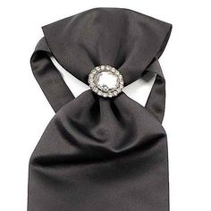 Elevate your formal attire with our Ascot Tie with Jewel Ring. This exquisite accessory combines the timeless elegance of a classic ascot tie with a touch of contemporary flair, thanks to the addition of a decorative jewel ring. Made from luxurious fabric, this ascot offers a sophisticated, rich texture and an impeccable drape. The jewel ring serves as both a stylish focal point and a practical solution to keep the ascot neatly in place. Perfect for weddings, formal events, or any occasion where Silver Elegant Suit And Tie Accessories For Gift, Elegant Silver Suit And Tie Accessories For Gift, Classic Adjustable Jewelry For Party, Elegant Jewelry Brooch, Classic Formal Brooch Jewelry, Classic Formal Jewelry Brooch, Classic Formal Brooch, Elegant Silver Suit And Tie Accessories For Party, Elegant Adjustable Accessories For Black Tie Events