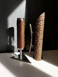 two tall vases sitting next to each other on a table