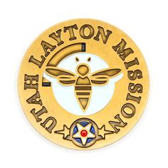 a gold and white badge with a bee on it