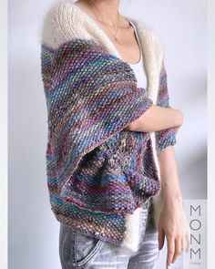 a woman wearing a multicolored knitted shawl