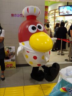 an inflatable chicken is standing on the floor