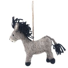 a gray and black horse ornament hanging from a string on a white background