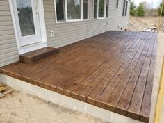 a wooden deck in front of a house