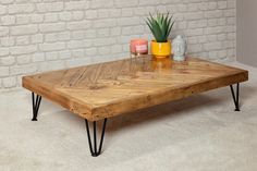 a coffee table with hairpin legs and a potted plant on top