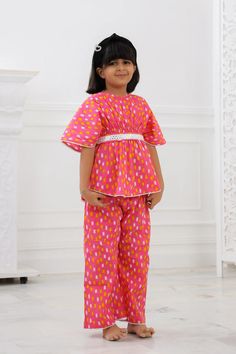 Our Girls Kurta Salwar is a must-have for your Girls. Made with 100% pure cotton cambric, this kurta is quite soft and tactile to touch making it a perfect match for your small one. Traditional print in pretty colours makes this kurta look distinctively good while wearing it. Composition: 100% cotton cambric The Kaftan Set is a gorgeous set of two pieces, includes a white cotton lace on Kaftan sleeves, Kaftan flare & pant bottom. The elasticated kaftan with a belt & loop for belt and elasticized pants to match, it has a button at the back that can be made secure or open, as you wish! Wash care : Hand wash separately in cold water. Use mild detergent. Dry in shade. Anarkali Cotton Set For Puja, Festive Cotton Kurta With Short Sleeves, Summer Cotton Kurta For Puja, Festive Short Sleeve Cotton Kurta, Cotton Bandhani Print Sets For Summer, Pink Cotton Sets For Diwali, Short Sleeve Cotton Sets For Eid, Summer Cotton Sets With Bandhani Print, Cotton Kurta With Printed Motifs And Short Sleeves