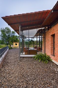 a brick building with glass doors on the front and side walls that are covered in gravel