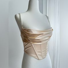 Brand New! Excellent Condition! - Size Us 2 - Beige Color - Very Flattering With Cinch Waist Corset And Draped Bustier - Beautiful Crystal Straps That Are Adjustable - Clasp In The Back Along With Zipper - Very Well Made And Constructed - Perfect For Birthdays Or A Night Out! Sleeveless Satin Corset With Built-in Bra, Cream Corset Top, Corset Bodice Pattern, Strapless Camisole With Corset Back For Party, Fitted Strapless Satin Crop Top, Elegant Fitted Camisole Corset, Fitted Camisole With Boned Bodice For Parties, Elegant Crop Top With Built-in Bra, Party Camisole With Adjustable Straps And Underbust Shape